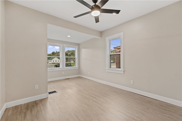 empty room with light hardwood / wood-style floors and ceiling fan