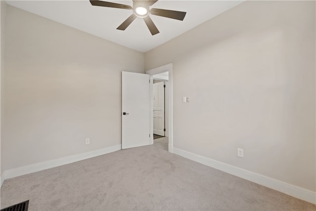 carpeted spare room with ceiling fan