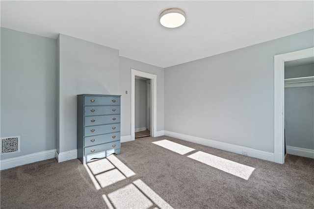 unfurnished bedroom featuring a closet and carpet flooring