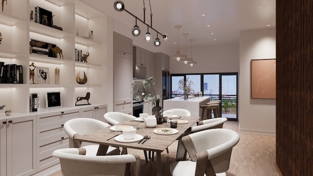 dining space featuring a towering ceiling and light wood-type flooring