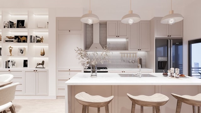 kitchen with sink, appliances with stainless steel finishes, wall chimney exhaust hood, hanging light fixtures, and decorative backsplash