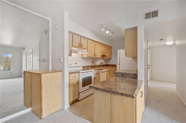 kitchen featuring light brown cabinets, light colored carpet, rail lighting, and white appliances