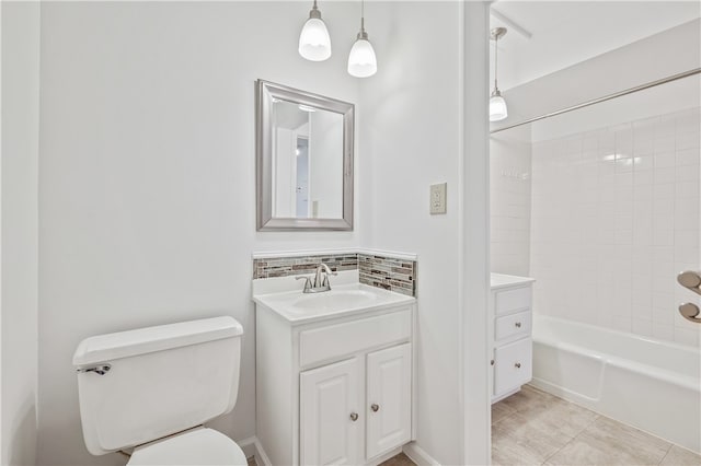 full bathroom featuring toilet, tiled shower / bath combo, vanity, and tile patterned flooring