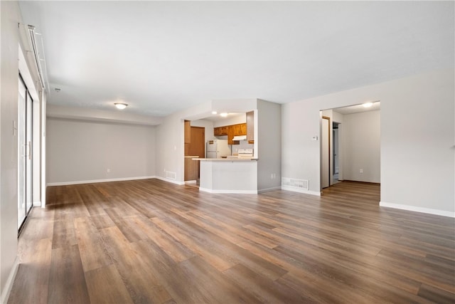 unfurnished living room featuring hardwood / wood-style flooring