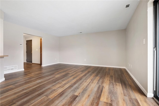 unfurnished room with dark hardwood / wood-style flooring