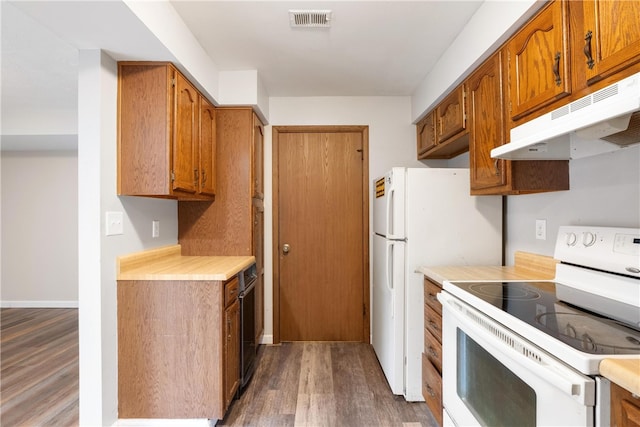 kitchen with white appliances and dark hardwood / wood-style floors