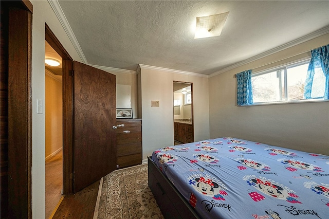 bedroom with ornamental molding, a textured ceiling, dark hardwood / wood-style floors, and ensuite bathroom