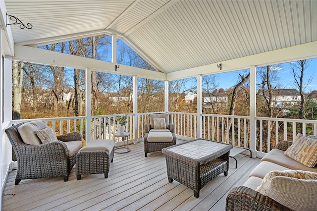 sunroom with a healthy amount of sunlight and vaulted ceiling