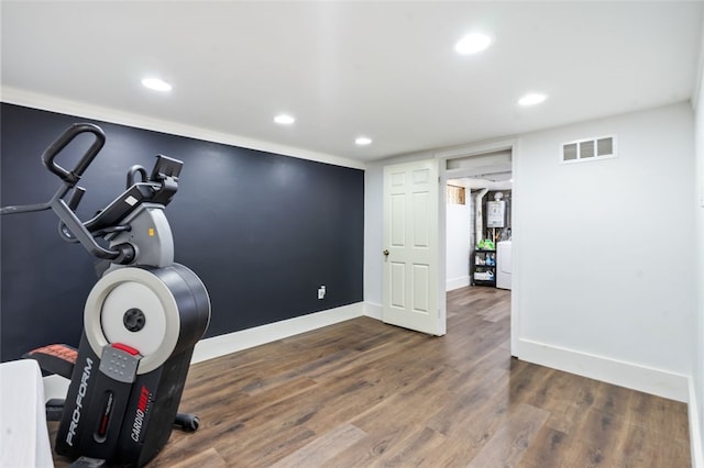 exercise area featuring dark hardwood / wood-style flooring and washer / clothes dryer