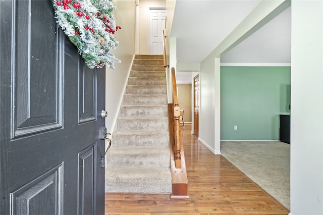 entrance foyer featuring hardwood / wood-style flooring and crown molding