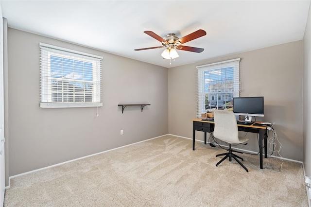 office space with ceiling fan and light colored carpet