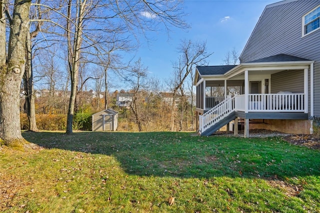 view of yard with covered porch and a storage shed