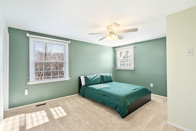 bedroom featuring ceiling fan and light carpet