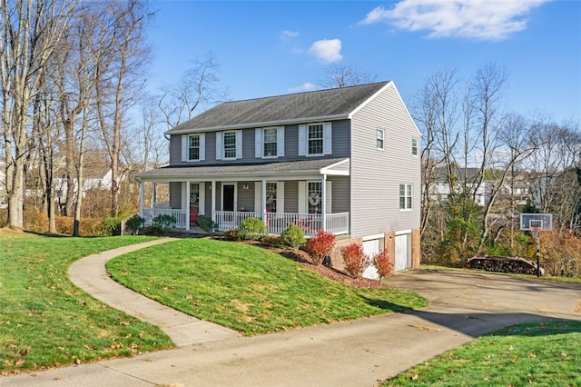 view of front of property with a porch, a garage, and a front lawn