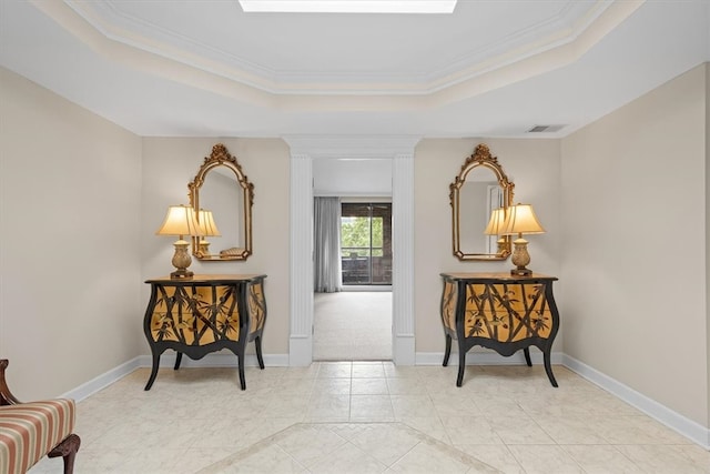 sitting room with a tray ceiling and crown molding