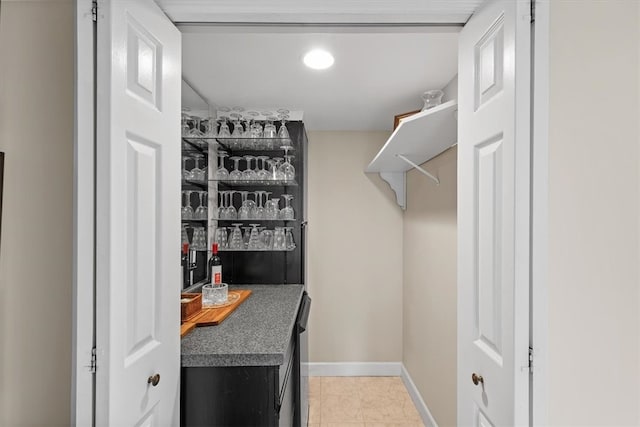 walk in closet featuring bar and light tile patterned flooring