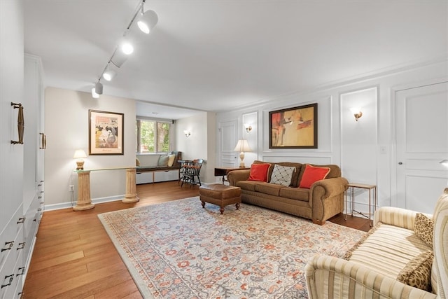 living room featuring light hardwood / wood-style floors and rail lighting