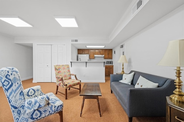 carpeted living room with crown molding