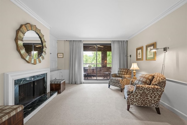 carpeted living room with ceiling fan, ornamental molding, and a fireplace