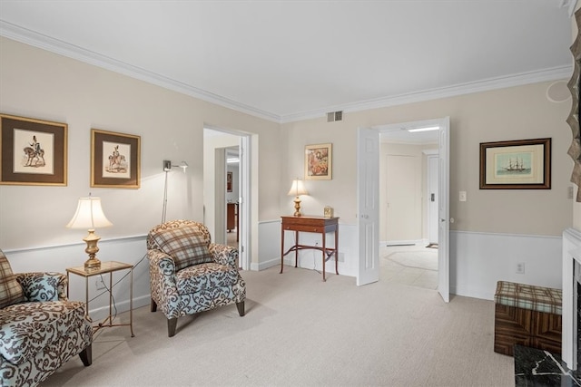 sitting room with light carpet and crown molding