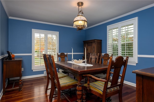 dining area with dark hardwood / wood-style floors, an inviting chandelier, and ornamental molding