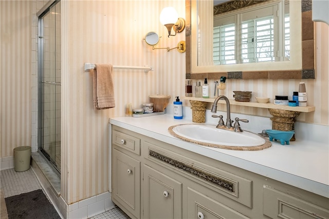 bathroom with walk in shower, vanity, and tile patterned floors