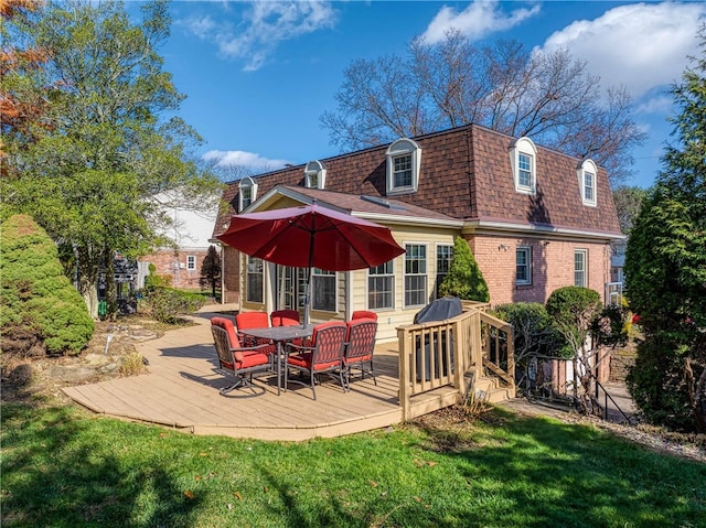 rear view of house with a lawn and a wooden deck