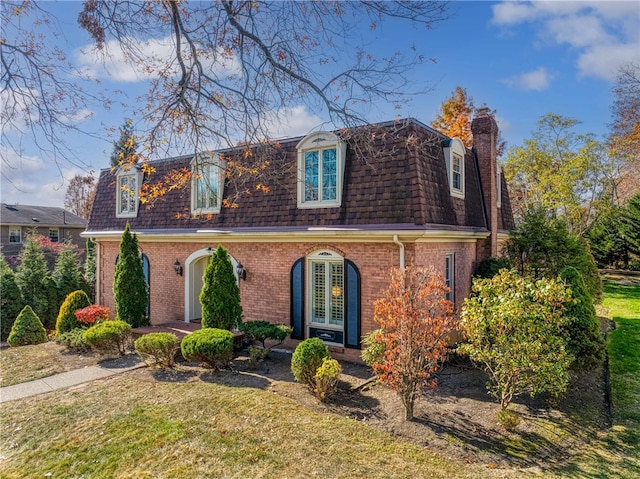 view of front of home featuring french doors and a front yard