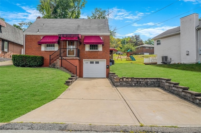 view of front of house featuring a garage, central air condition unit, and a front lawn