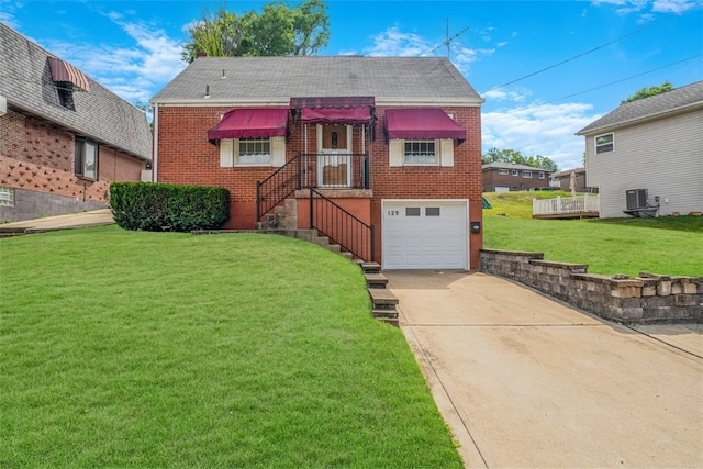 view of front of home featuring a garage, a front lawn, and central AC