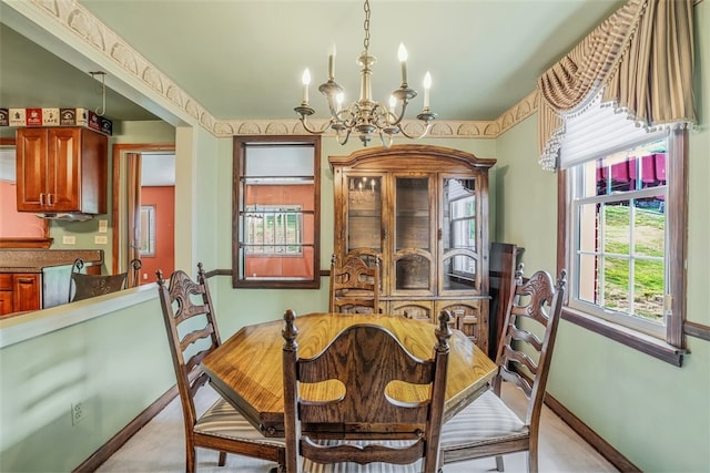 dining space with light colored carpet and a notable chandelier