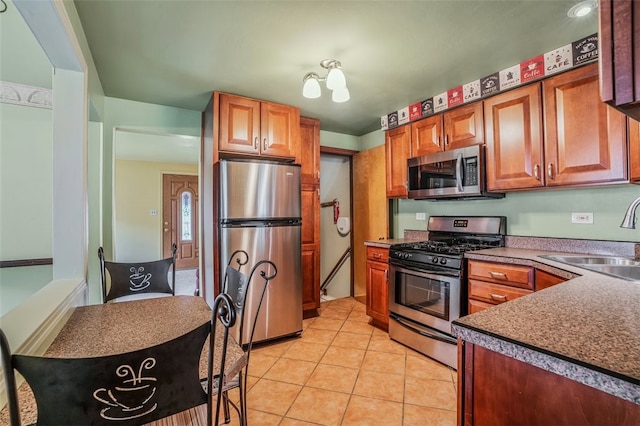 kitchen featuring sink, light tile patterned floors, and stainless steel appliances