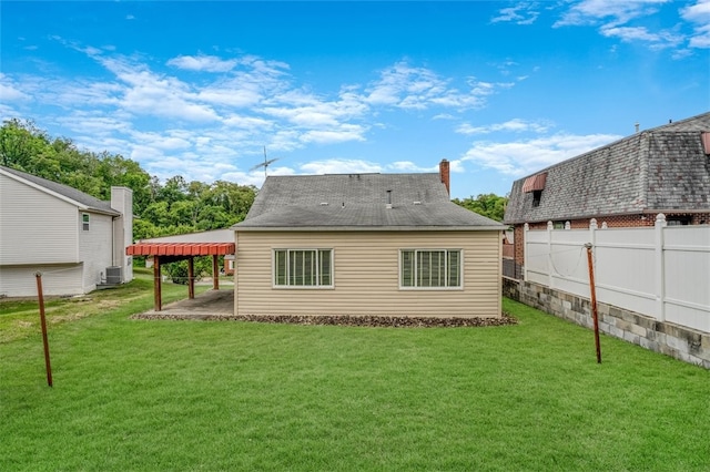 rear view of house featuring a yard and a patio area