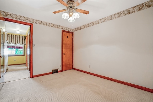 unfurnished room with light carpet and ceiling fan