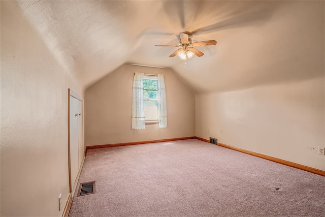 bonus room featuring ceiling fan, vaulted ceiling, and carpet