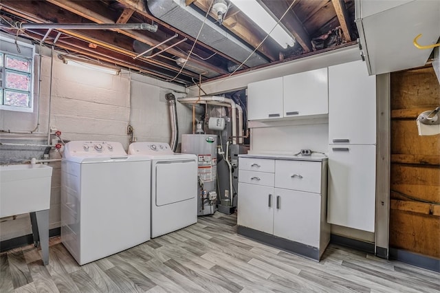 laundry room with washer and clothes dryer, light wood-type flooring, water heater, cabinets, and sink