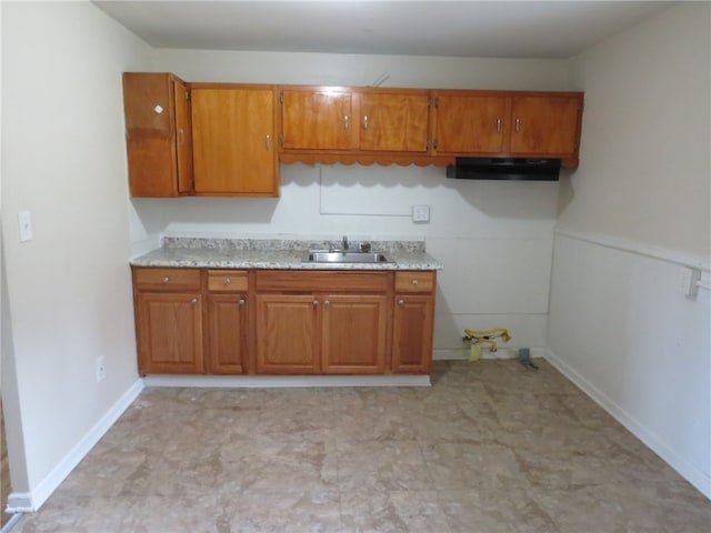 kitchen with sink and light stone counters