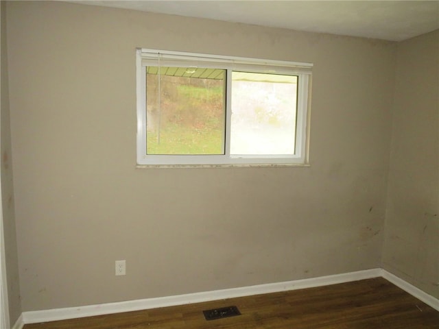 empty room with dark wood-type flooring