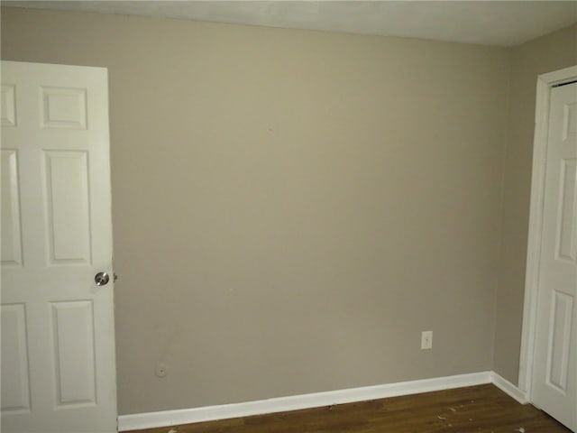 spare room with dark hardwood / wood-style flooring