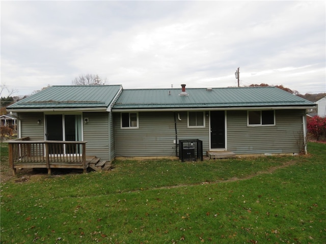 rear view of property featuring a lawn