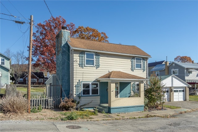 view of front facade featuring an outbuilding and a garage