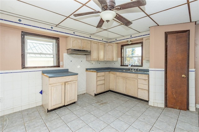 kitchen featuring ceiling fan, light brown cabinets, light tile patterned floors, and sink