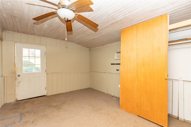 interior space featuring light carpet, a wall unit AC, ceiling fan, and wood ceiling