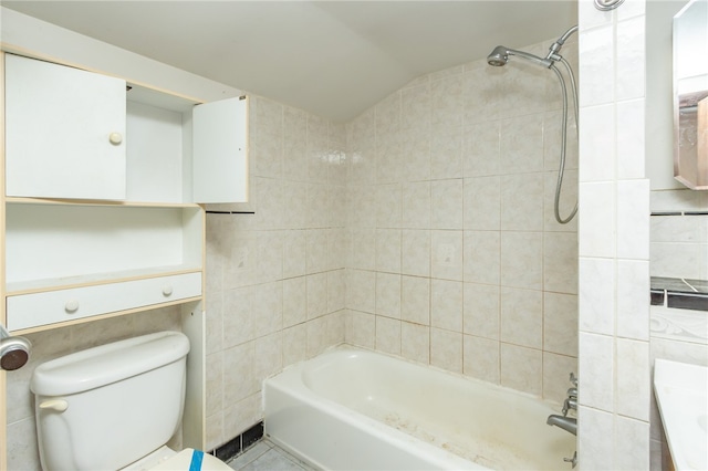 full bathroom featuring vanity, vaulted ceiling, toilet, and tiled shower / bath