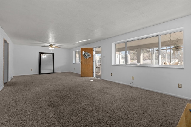 unfurnished living room with ceiling fan, a healthy amount of sunlight, and carpet flooring