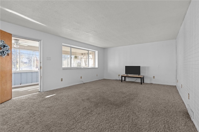 unfurnished living room with ceiling fan, carpet, and a healthy amount of sunlight