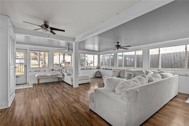 living room featuring beamed ceiling, ceiling fan, and dark hardwood / wood-style flooring