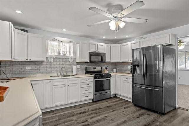 kitchen with white cabinets, stainless steel appliances, sink, and plenty of natural light