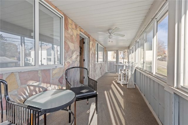 sunroom featuring ceiling fan