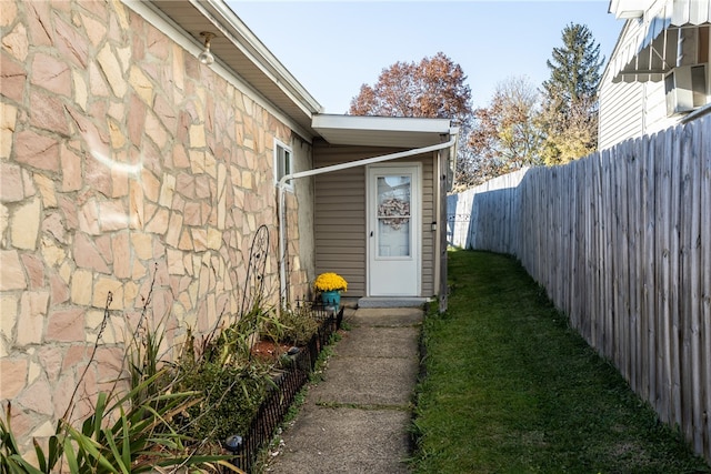 doorway to property featuring a yard